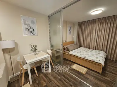 Cozy studio apartment with modern decor and sliding glass partition