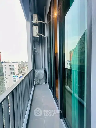Modern high-rise balcony with city view and sleek glass doors