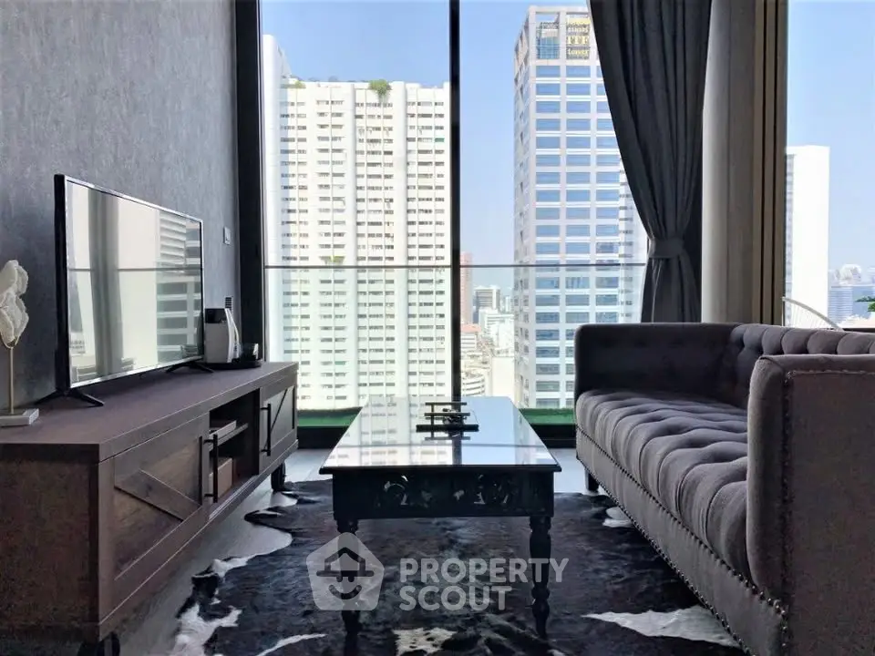 Modern living room with stunning city view, featuring sleek furniture and floor-to-ceiling windows.