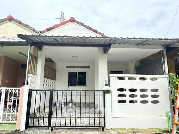 Charming single-story house with covered porch and gated entrance in a serene neighborhood.