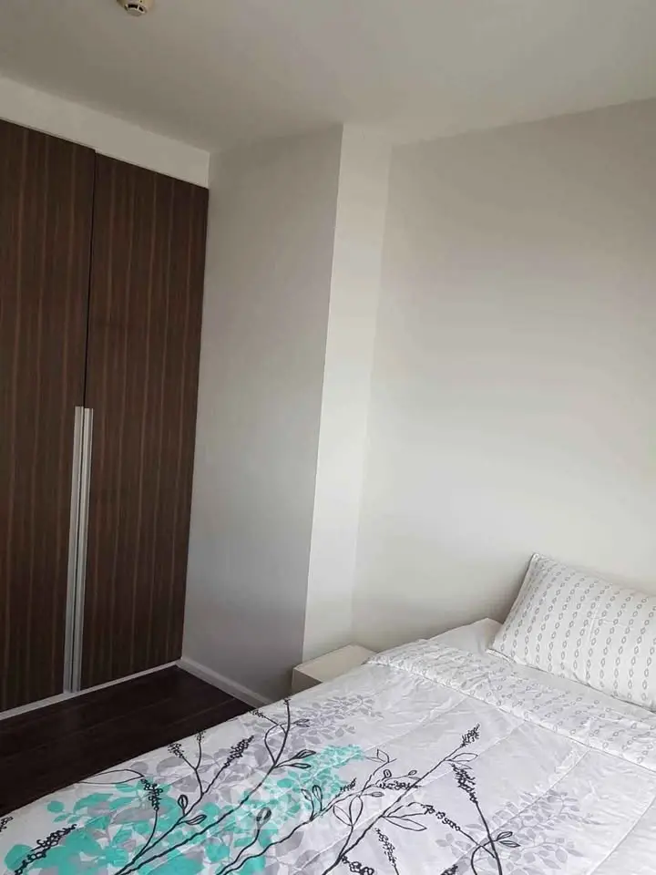 Cozy bedroom with modern wardrobe and stylish bedding in a contemporary apartment.