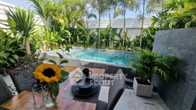 Luxurious private pool area with lush greenery and elegant outdoor dining setup.