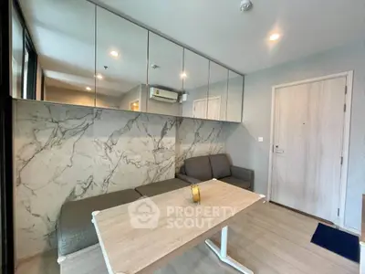 Modern living room with stylish marble accent wall and sleek furniture