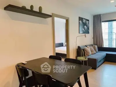 Modern living room with dining area and stylish decor in a cozy apartment.