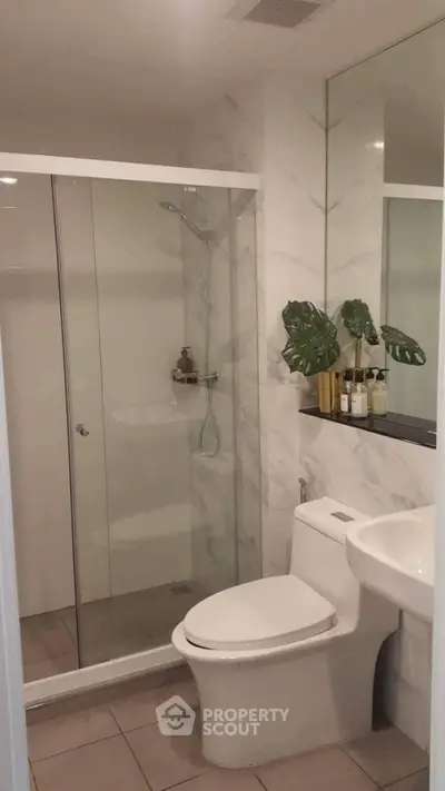 Modern bathroom with glass shower and sleek fixtures