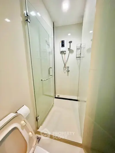 Modern bathroom with glass shower enclosure and sleek fixtures