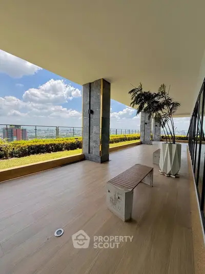 Spacious balcony with stunning city view and modern decor, perfect for relaxation and entertainment.