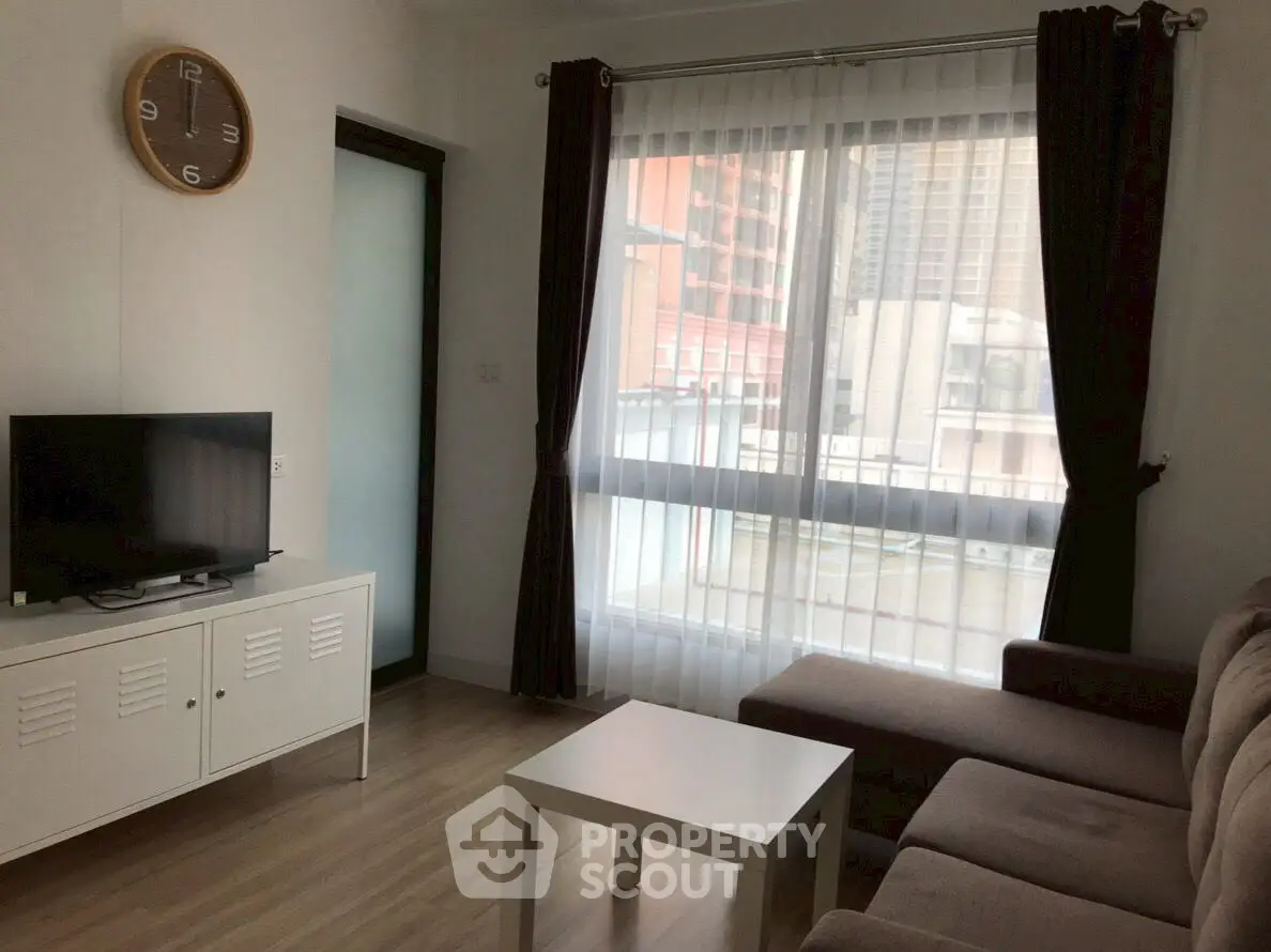 Cozy living room with modern decor and large window view