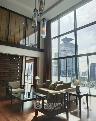 Luxurious living room with floor-to-ceiling windows offering stunning city views in a modern high-rise apartment.