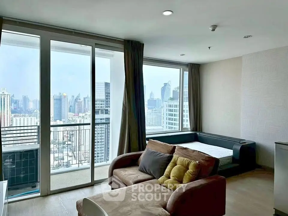 Spacious living room with city view and large windows in modern apartment
