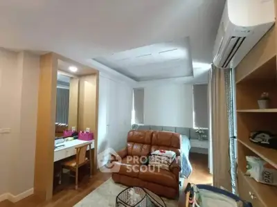 Cozy living room with modern furniture and air conditioning in a stylish apartment.