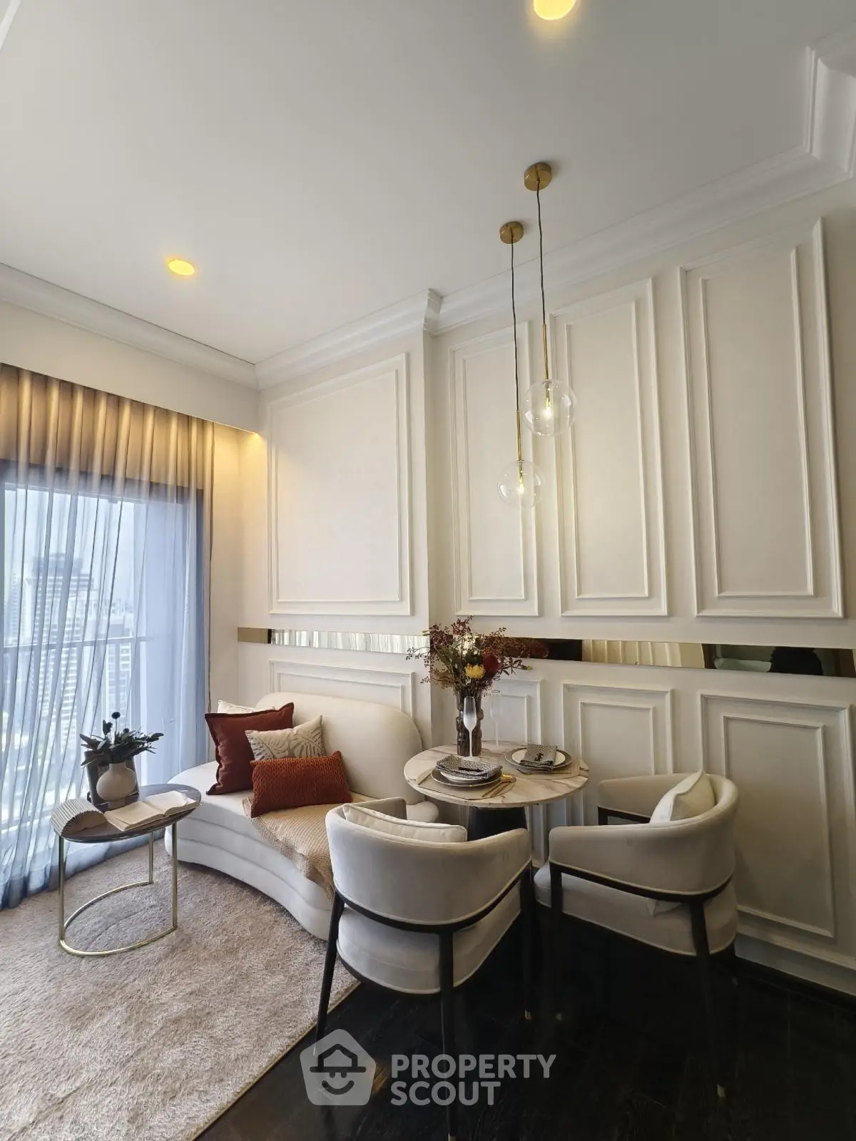 Elegant living room with modern decor and city view, featuring plush seating and stylish lighting.