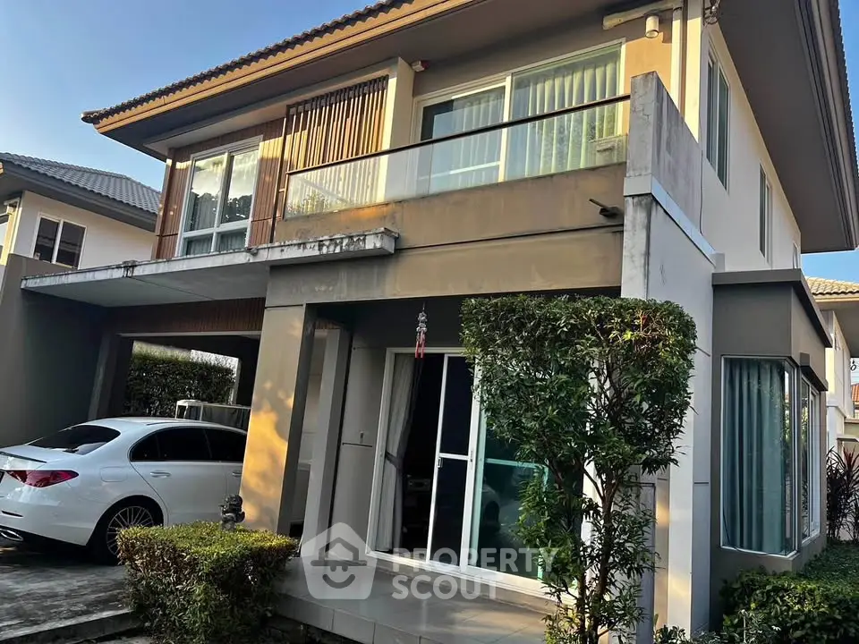 Modern two-story house with carport and landscaped garden