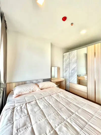 Bright and cozy bedroom with modern wardrobe and soft bedding