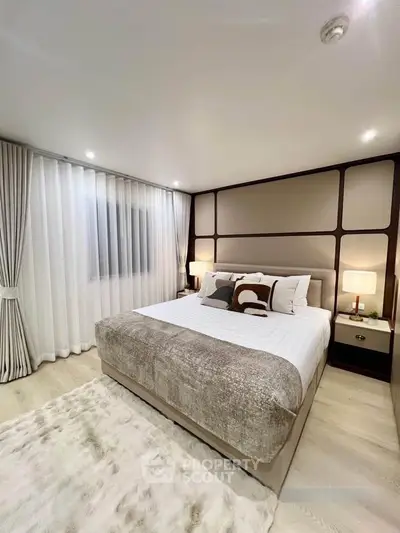 Luxurious modern bedroom with elegant decor and plush bedding