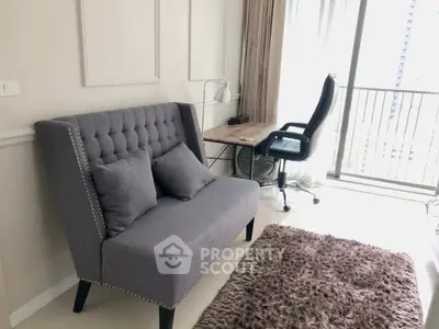 Stylish modern living room with plush sofa and workspace near balcony