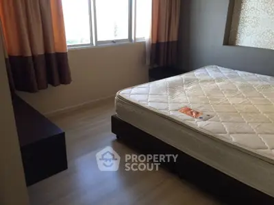 Spacious bedroom with large window and elegant curtains in modern apartment