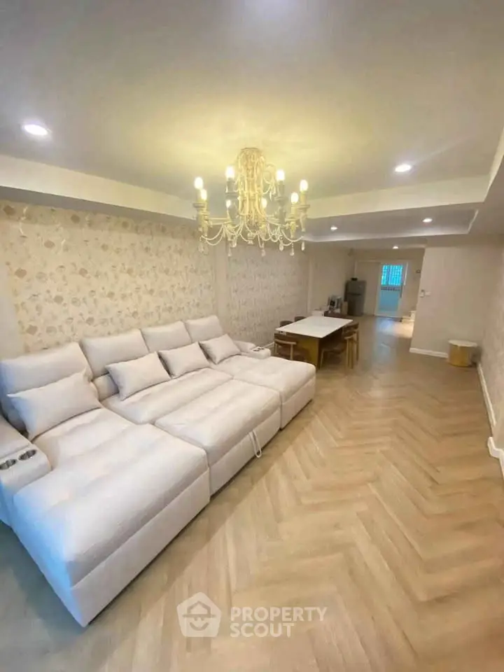 Elegant living room with luxurious chandelier and spacious seating area