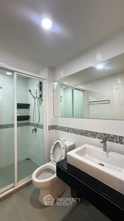 Modern bathroom with sleek fixtures and spacious shower area