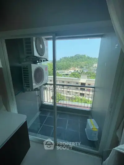 Cozy balcony with air conditioning units and scenic view of lush greenery.