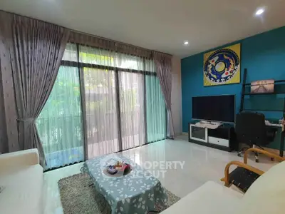 Spacious living room with large windows and modern decor in a stylish apartment.