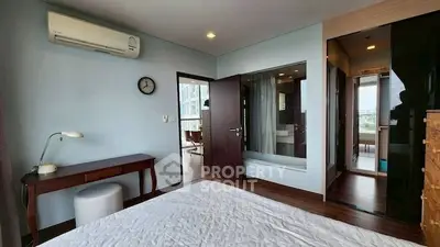 Modern bedroom with air conditioning and ensuite bathroom in a stylish apartment.