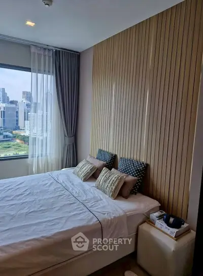 Modern bedroom with city view and stylish wooden paneling