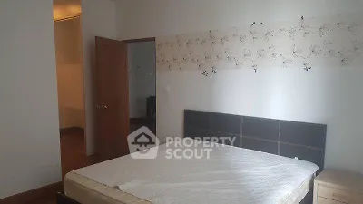 Spacious bedroom with elegant decor and comfortable bed in modern apartment.