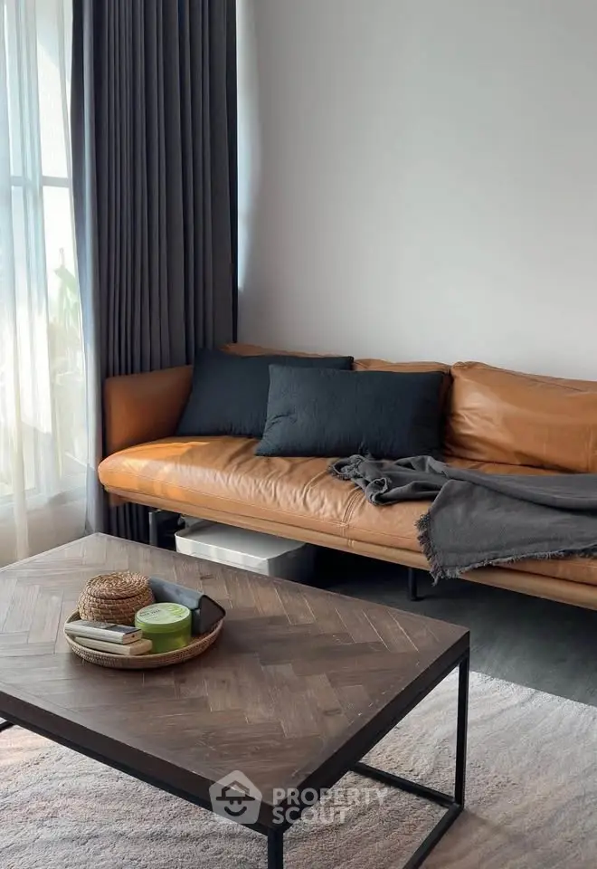Stylish living room with leather sofa and modern decor, perfect for cozy relaxation.