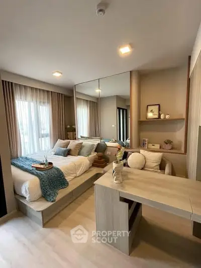Modern bedroom with stylish decor and natural light, featuring a cozy bed and elegant furnishings.