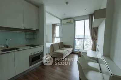 Modern studio apartment with open kitchen and city view, featuring sleek design and natural light.