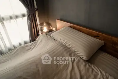 Cozy bedroom with modern lighting and elegant bedding