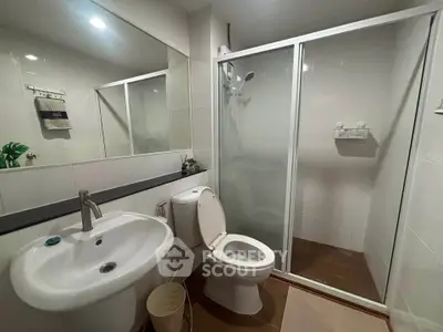 Modern bathroom with glass shower enclosure and sleek fixtures