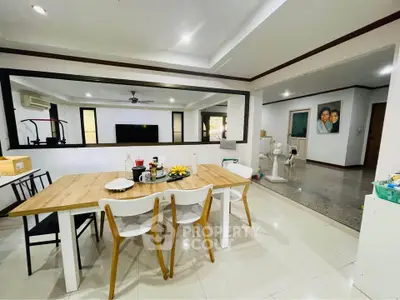 Spacious dining area with modern decor and open layout, perfect for family gatherings.