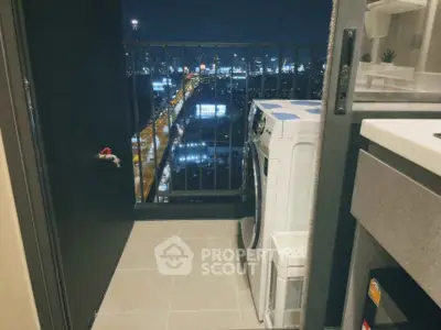 Chic urban balcony with city skyline view and modern washing machine setup.