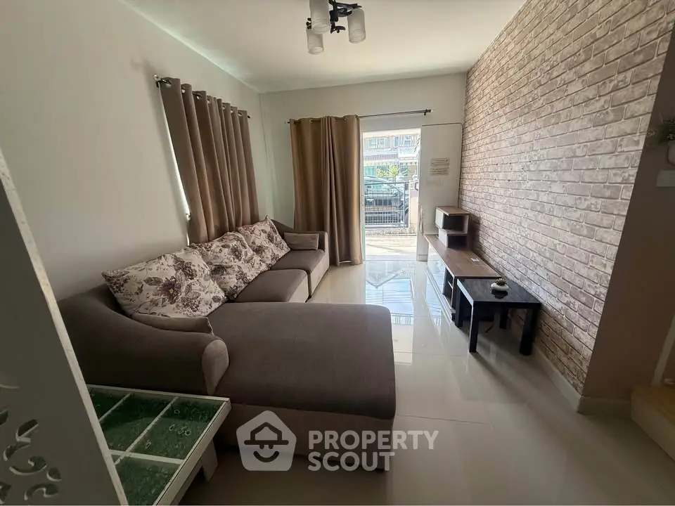 Cozy living room with modern sofa and brick accent wall