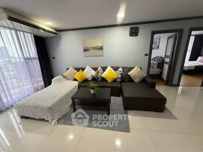 Spacious modern living room with sectional sofa and large windows