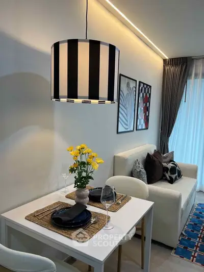 Stylish modern living room with elegant dining setup and cozy sofa