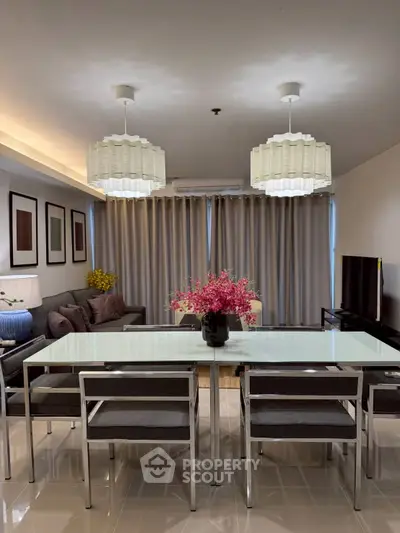 Modern living room with elegant dining area and stylish lighting fixtures.