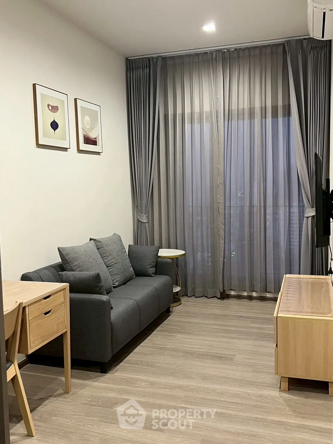 Modern living room with sleek furniture and large window view