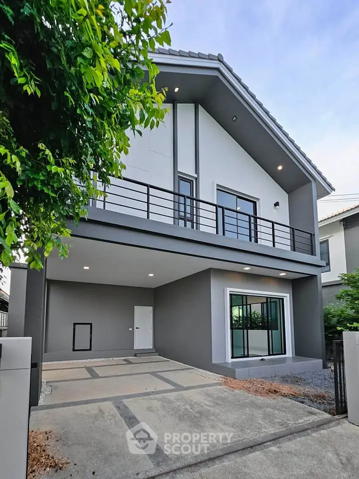 Modern two-story house with sleek design and spacious driveway