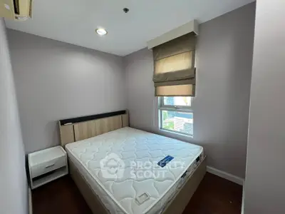Cozy bedroom with natural light and modern furnishings, ideal for restful living.