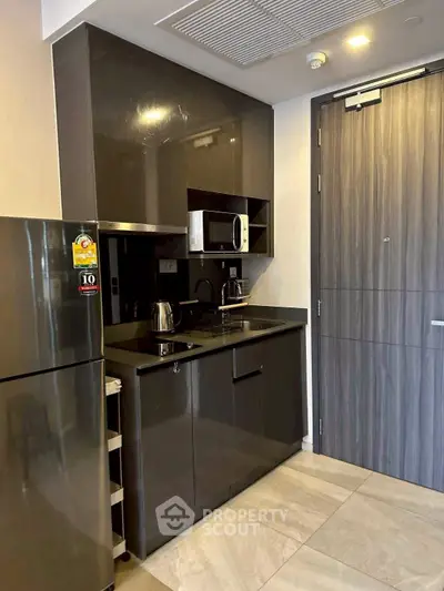 Modern kitchen with sleek cabinetry and stainless steel appliances in a compact layout.