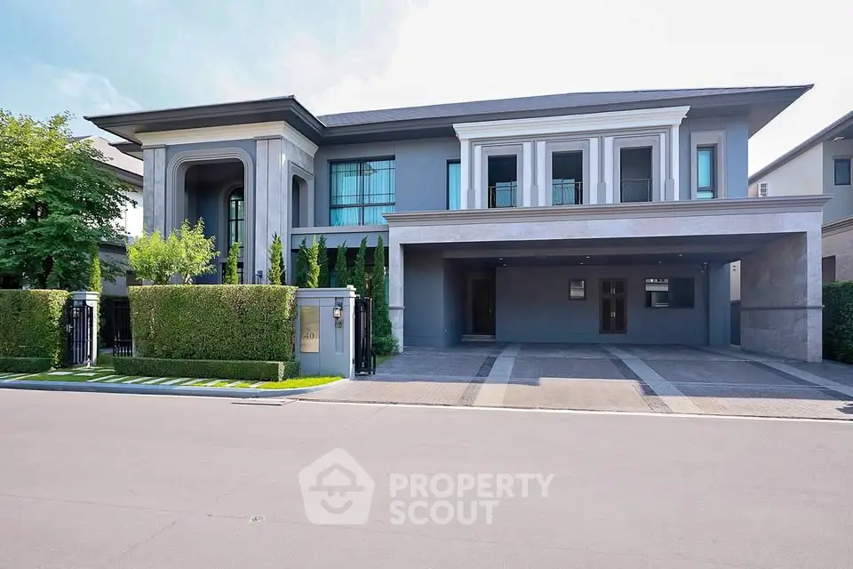 Luxurious modern mansion with grand entrance and spacious driveway in upscale neighborhood.