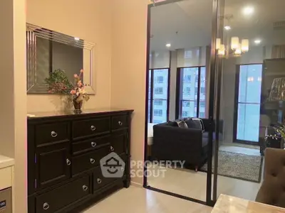 Modern living room with elegant black furniture and large mirror