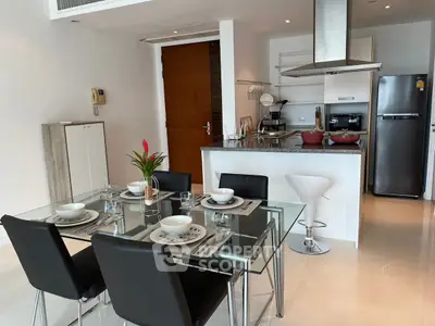 Modern open kitchen with dining area, sleek appliances, and elegant decor