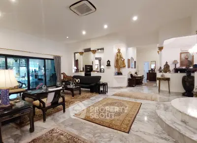 Luxurious living room with elegant decor and marble flooring in a spacious open layout.