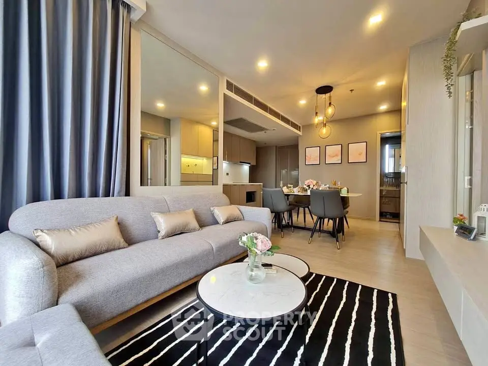 Modern living room with stylish decor and open kitchen layout in a luxurious apartment.