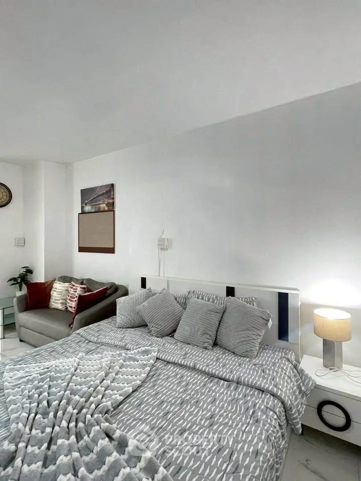 Cozy bedroom with modern decor and comfortable bedding in stylish apartment.