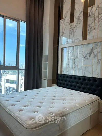 Luxurious bedroom with stunning city view and elegant marble accents